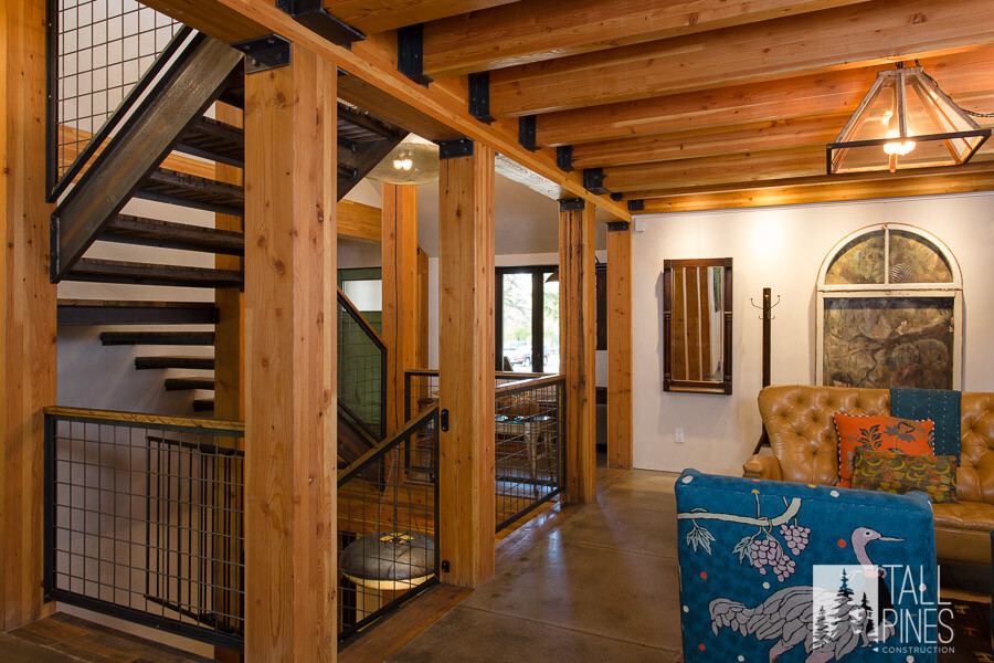 This staircase mixed industrial modern with reclaimed wood and LEED platinum elements to make this custom home remodel eco-friendly