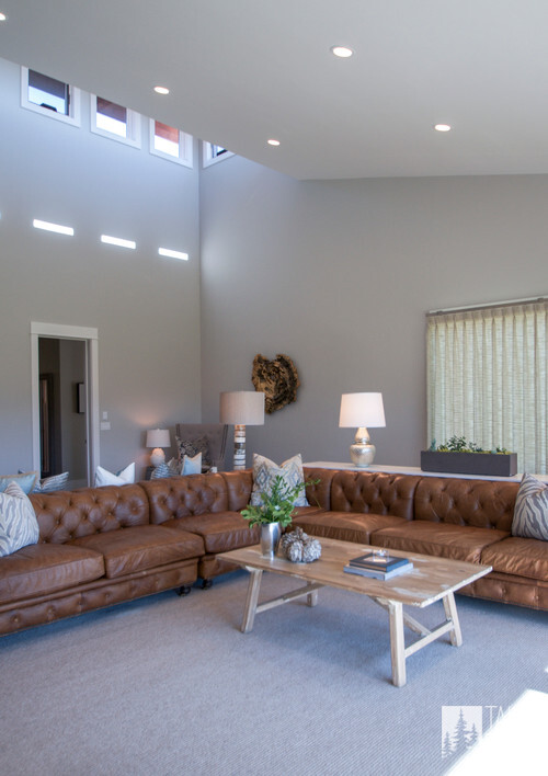 Living room featuring a large leather sofa and elegant decor by Utah custom homes