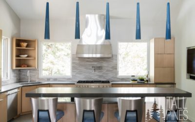 Modern kitchen with bar seating and stylish blue pendant lights