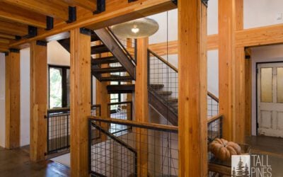 Wooden staircase with industrial accents in a green-certified home by Tall Pines Construction