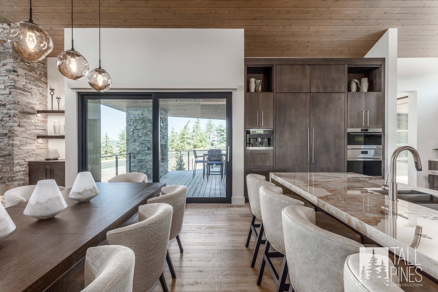 Dining Room Design With View Of Kitchen Island And Outside Deck, Built By A Park City Custom Home Builder.