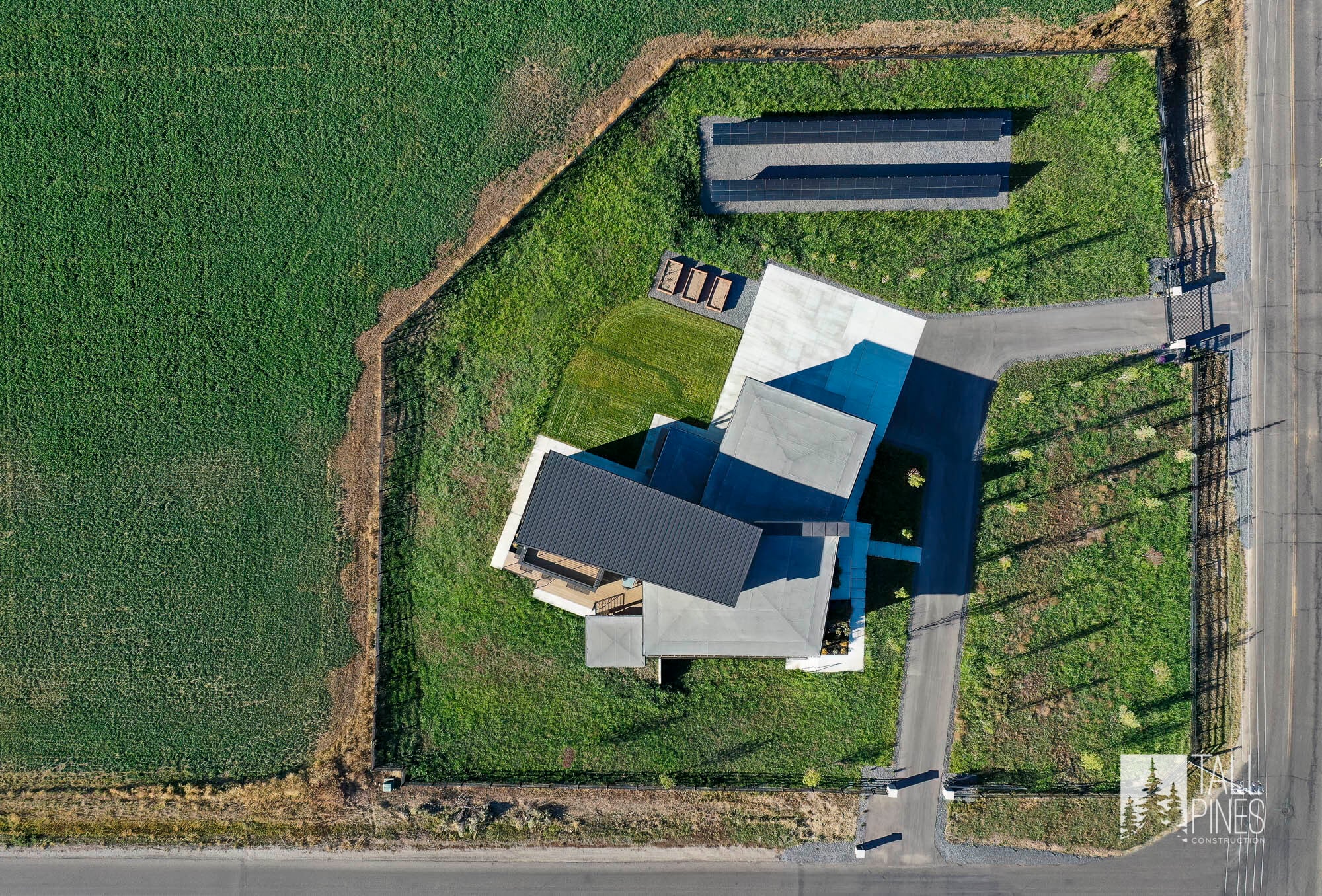 Aerial view of custom built home with solar panels on side yard at the Reservoir Retreat, a modern contemporary custom-built home in Midway, Utah by Tall Pines Construction.