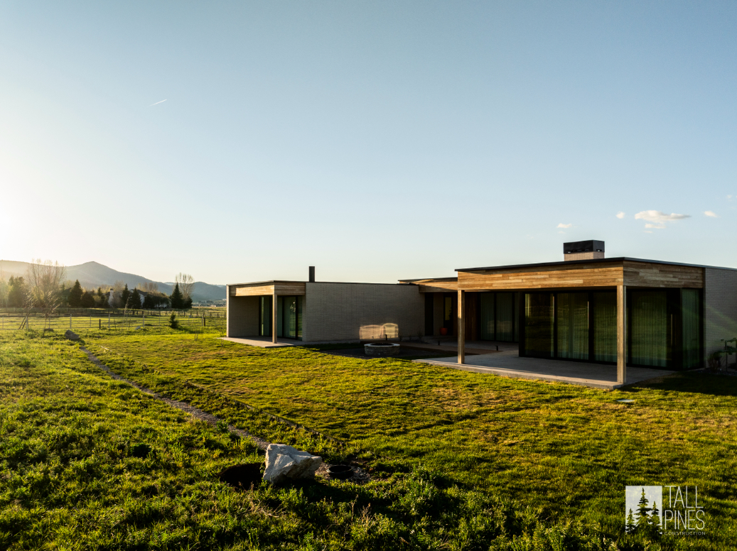 Sunset view of a modern mountain home in Park City with wood and glass design elements.