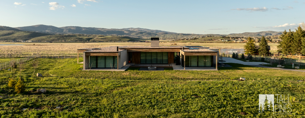 A modern mountain home in Park City with a central courtyard, covered patios, and mountain scenery in the background.