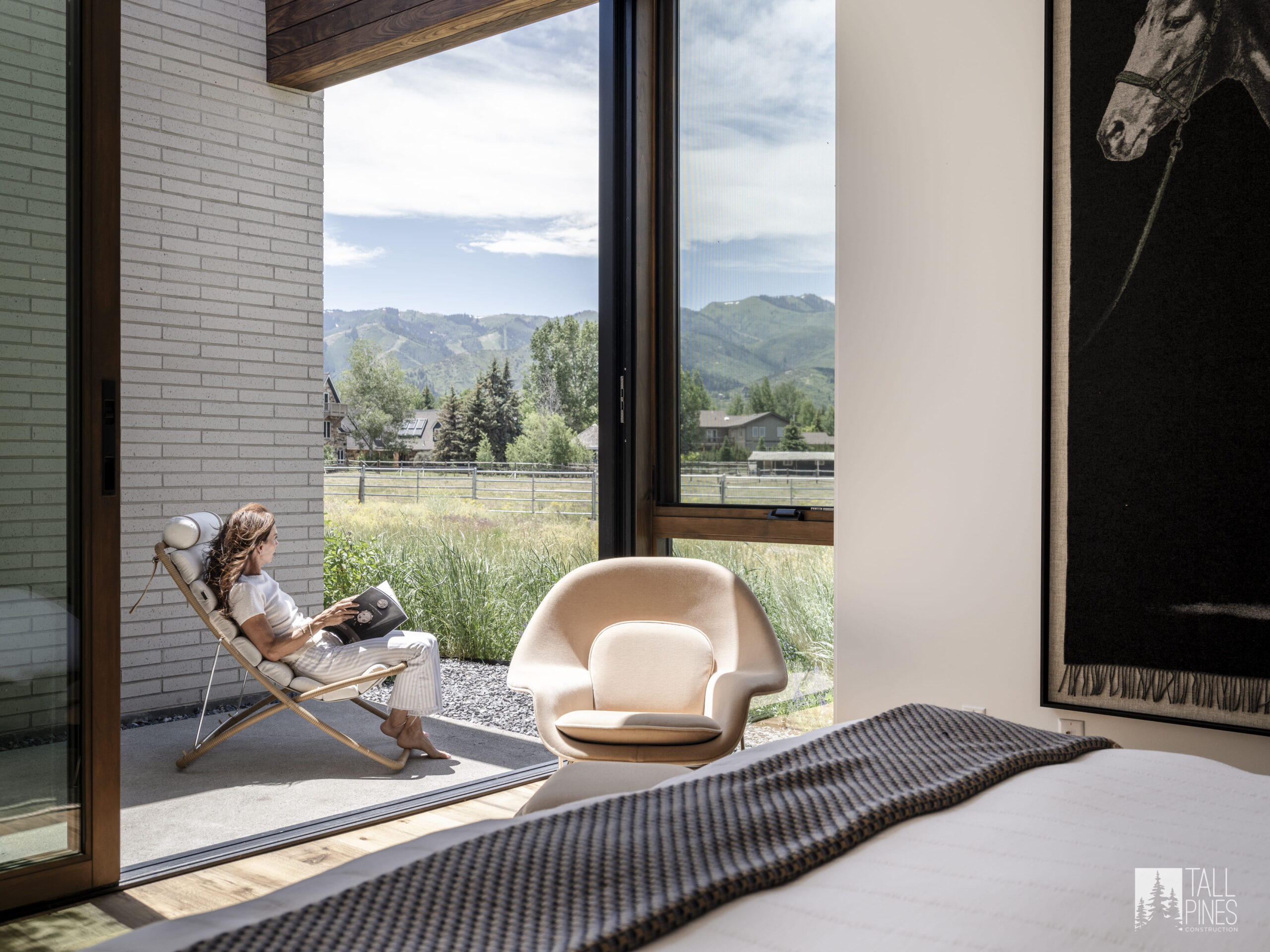 A serene bedroom seating area with mountain views for a Park City custom homes project by Tall Pines Construction in Park City, Utah.