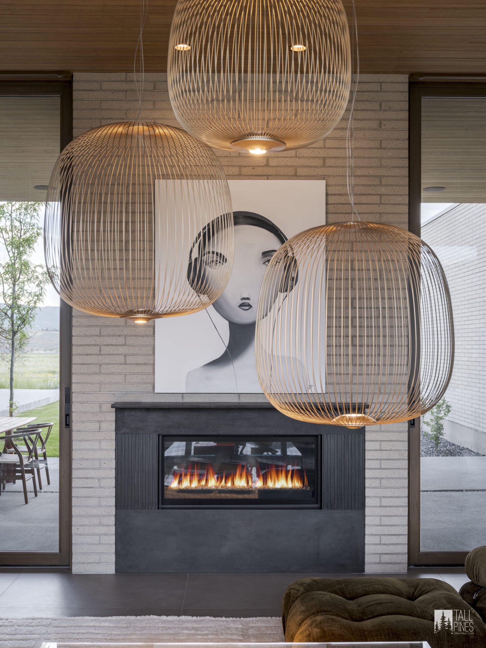 A modern fireplace with sculptural lighting for a Park City builders project by Tall Pines Construction in Park City, Utah.