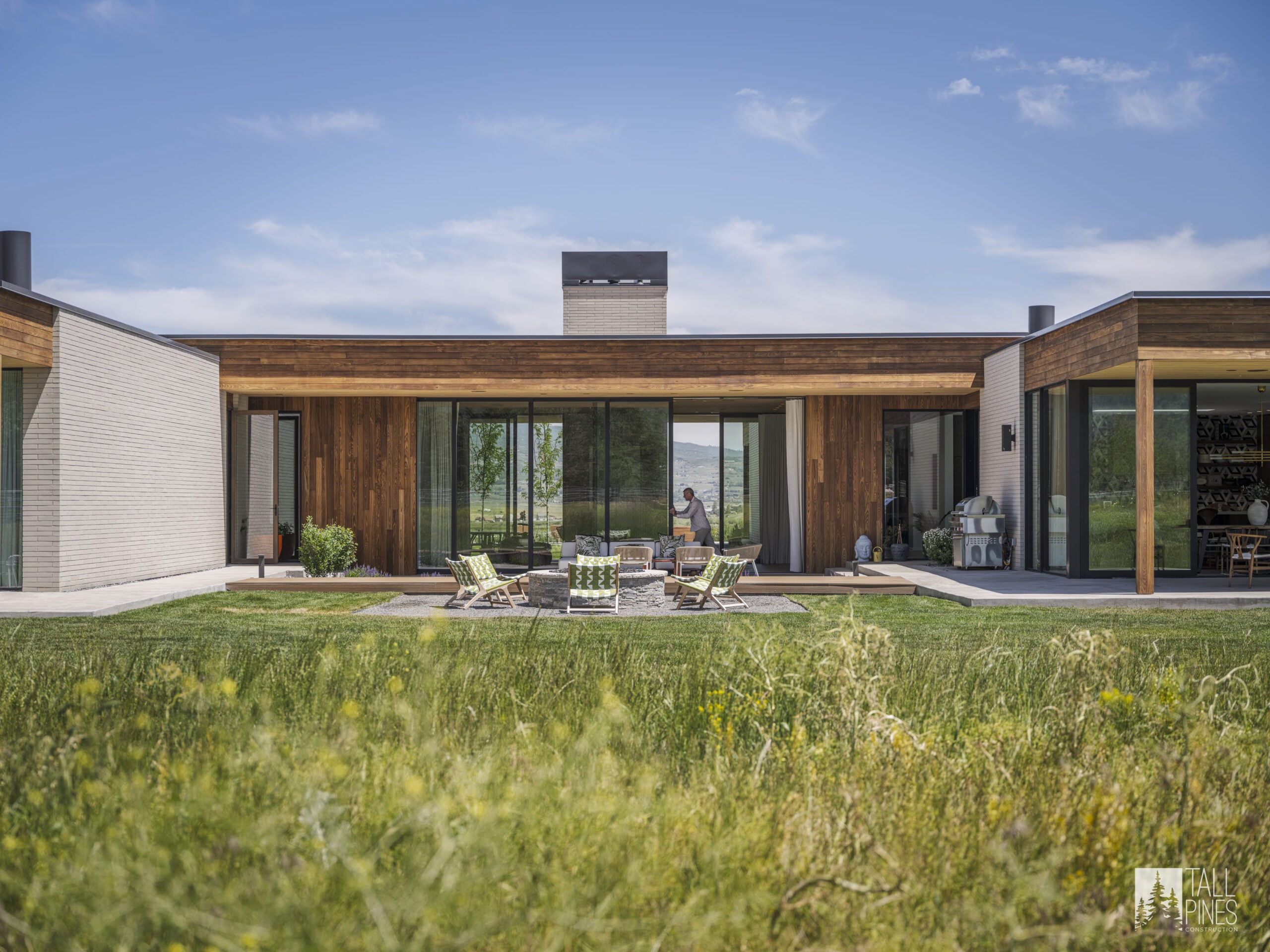 A modern mountain home exterior with patio seating for a Park City custom homes project by Tall Pines Construction in Park City, Utah.