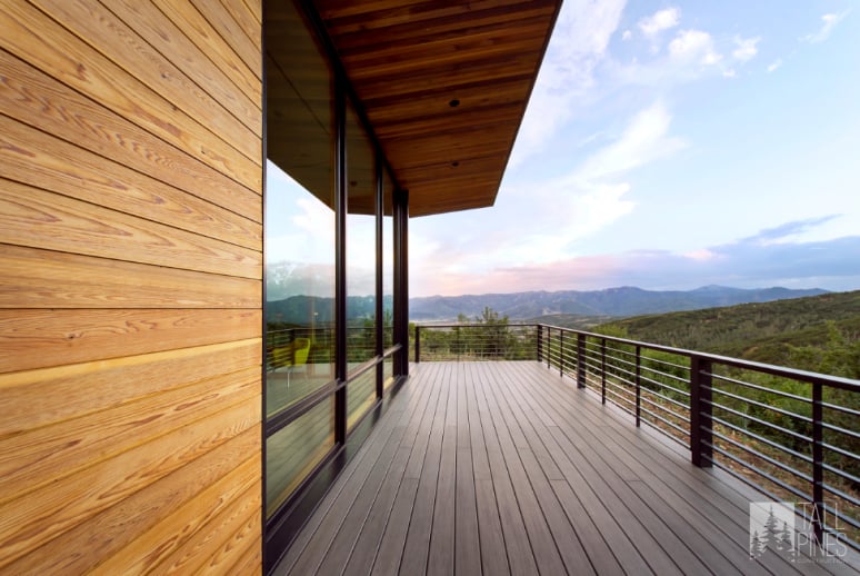 Custom Home Deck with Mountain Views in Park City A spacious deck on a custom-built Park City home showcasing clean architectural lines, natural wood siding, and expansive mountain views designed by Tall Pines Construction.