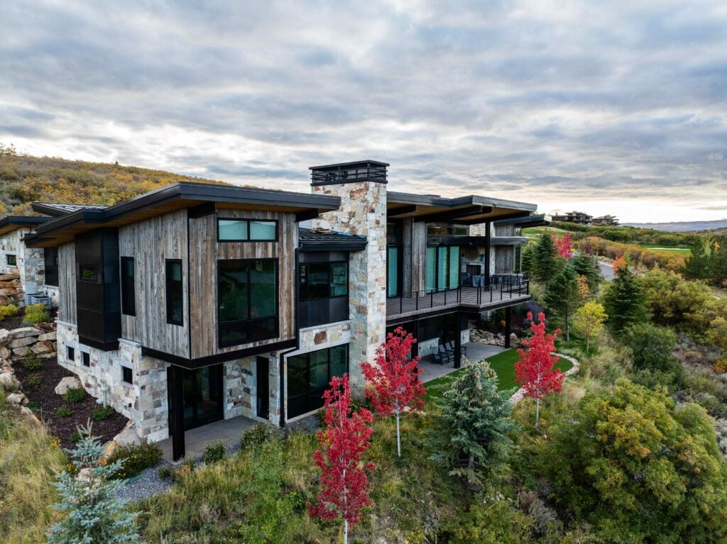 Exterior of a luxury Park City custom home showcasing mountain contemporary architecture, natural materials, and scenic hillside views.