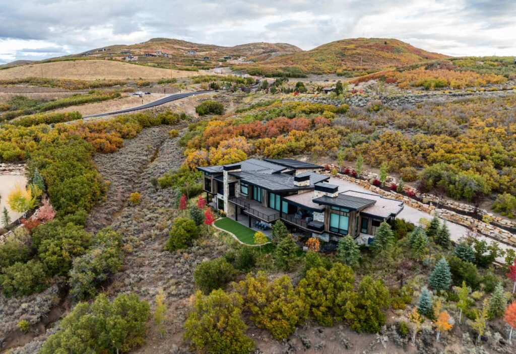 Aerial view of the Tuhaye community near Park City with custom homes, golf course, mountain terrain, and Jordanelle Reservoir.