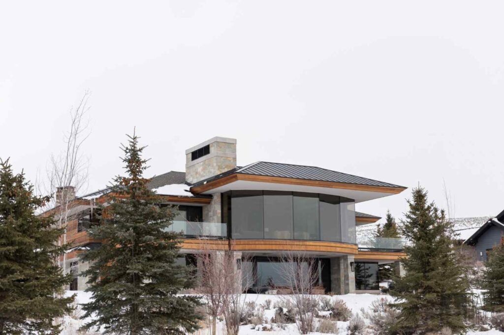 Modern Park City home in winter with large windows, natural materials, and a design suited to the high-altitude mountain climate.