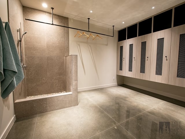 Custom ski locker and gear room in a Park City mountain home with built-in storage, hanging space, and durable flooring.