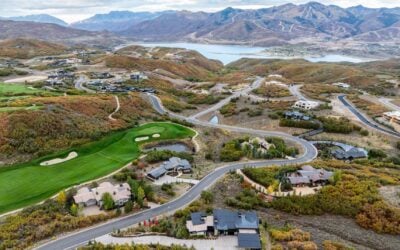 Aerial view of a modern custom mountain home surrounded by the rolling hills and fall landscape of Tuhaye.