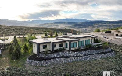 Aerial view of the Ridgeline Light custom home set into the rolling mountain landscape near Park City, Utah.
