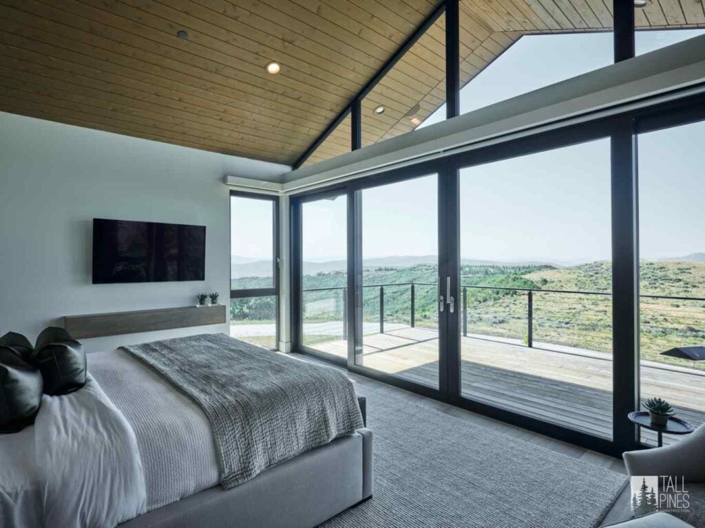 Mountain modern bedroom featuring floor-to-ceiling windows and expansive views of the Park City landscape.
