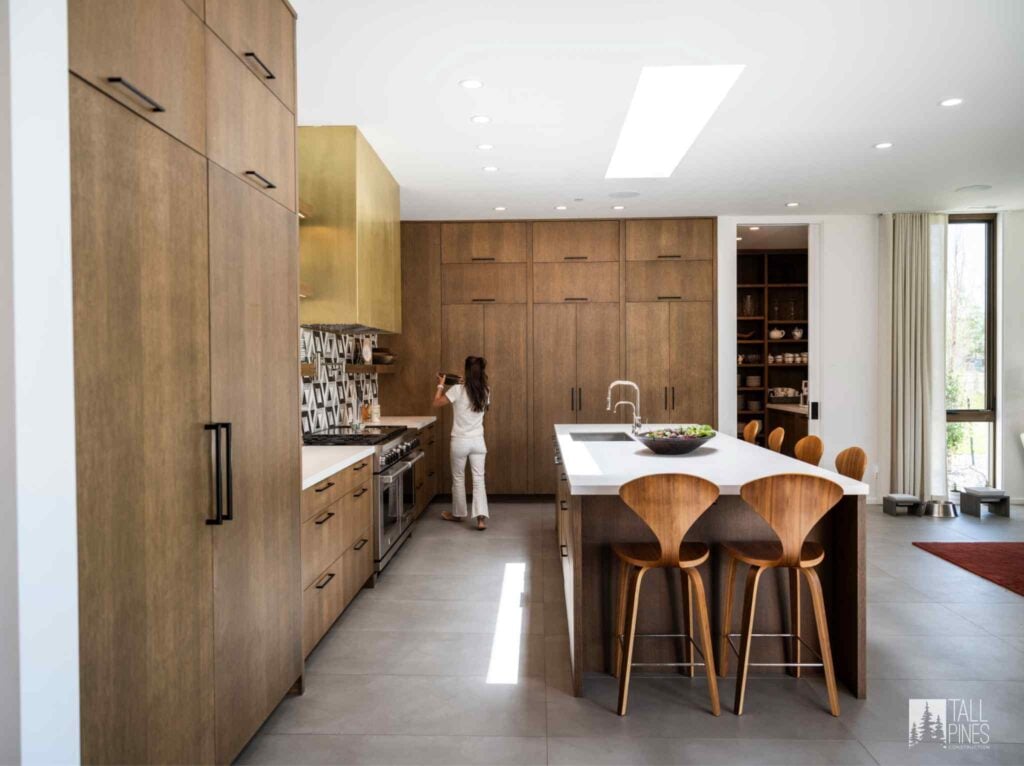 Mountain modern kitchen with warm wood cabinetry, contemporary finishes, and a large central island.