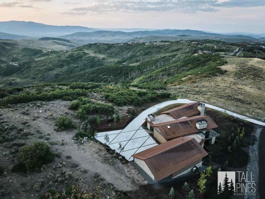 Aerial view of a custom home in Park City, Utah surrounded by mountain terrain.