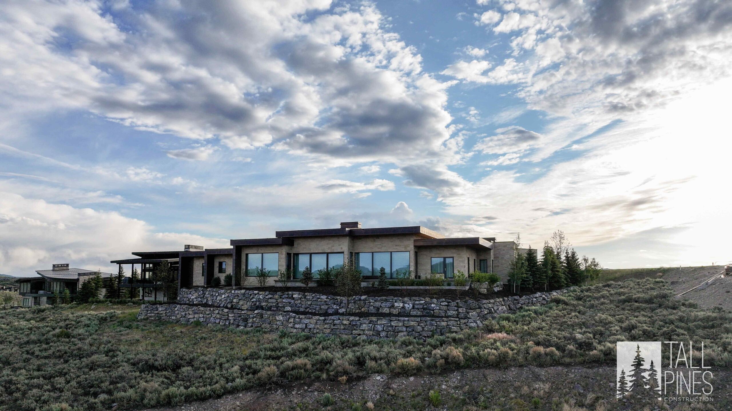 Wide exterior view of Ridgeline Light showing its low-profile contemporary design against the surrounding Utah mountain landscape.